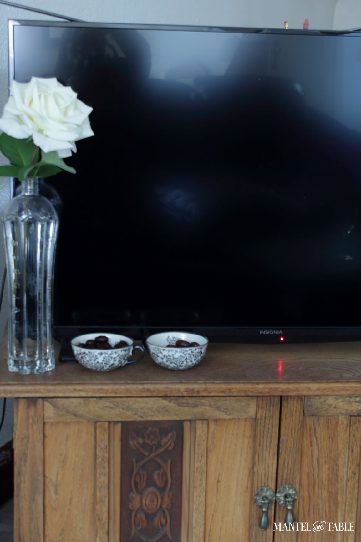 Black flowered teacups on TV table - closeup