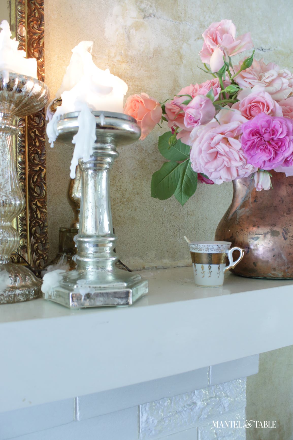 Teacups on mantel with candles, roses