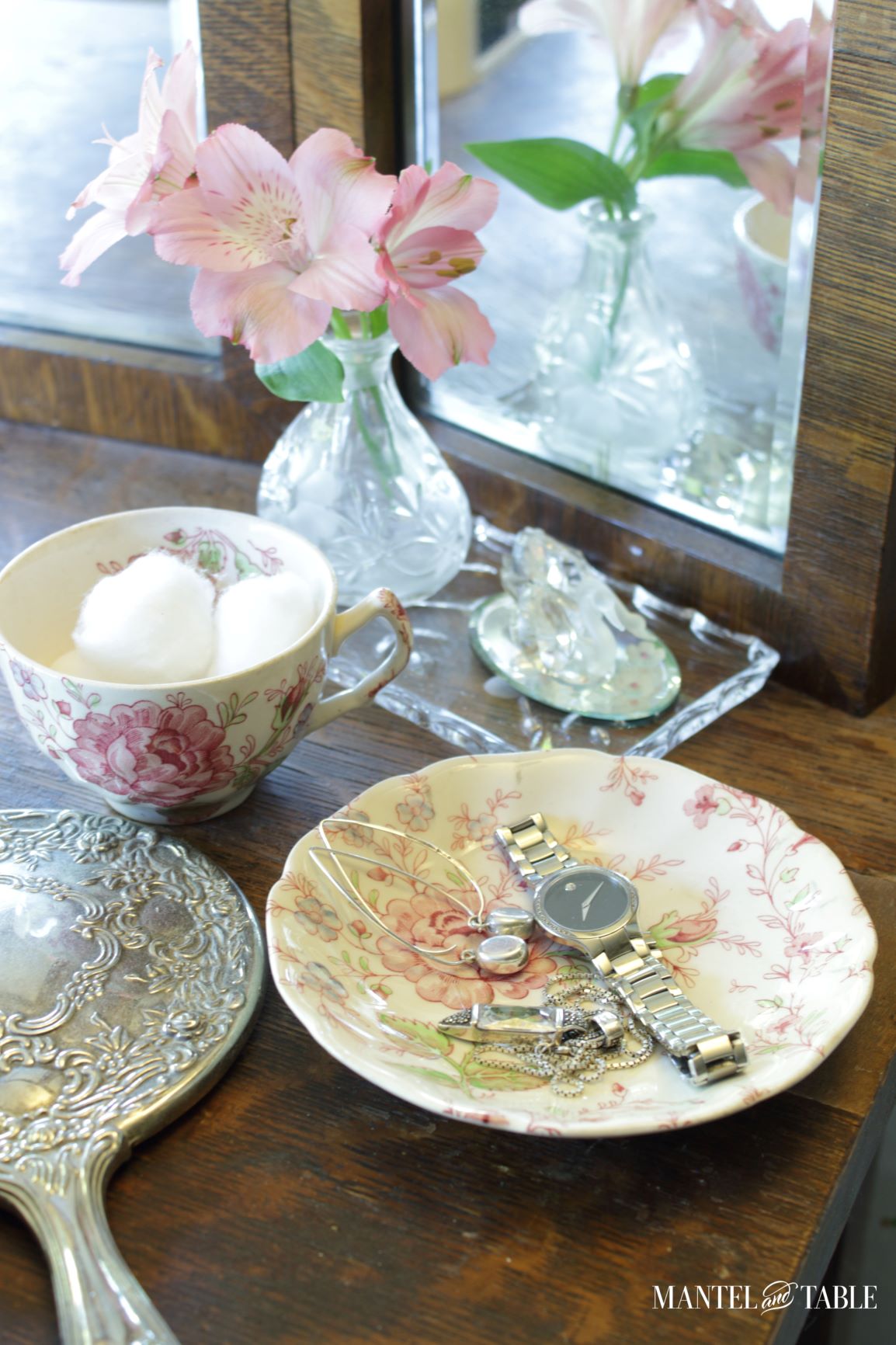 Teacup with cotton balls, saucer with jewelry.