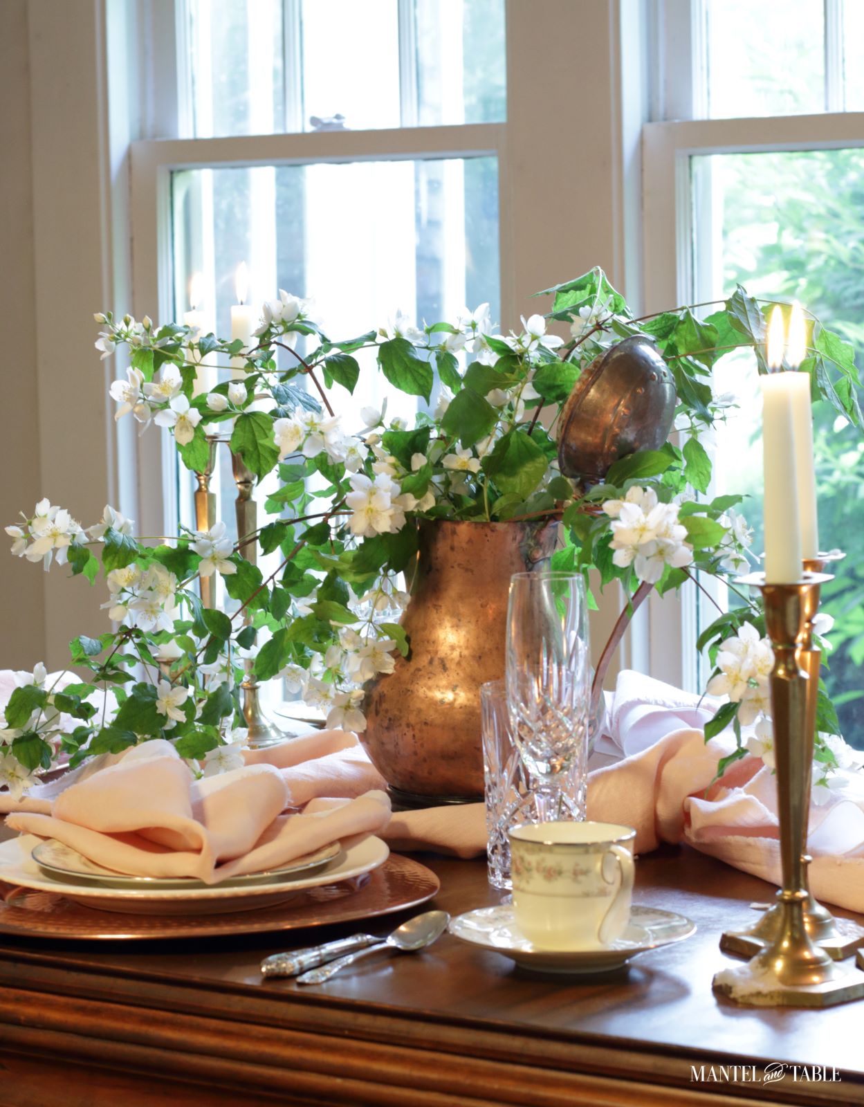Blush table linens with closeup of centerpiece