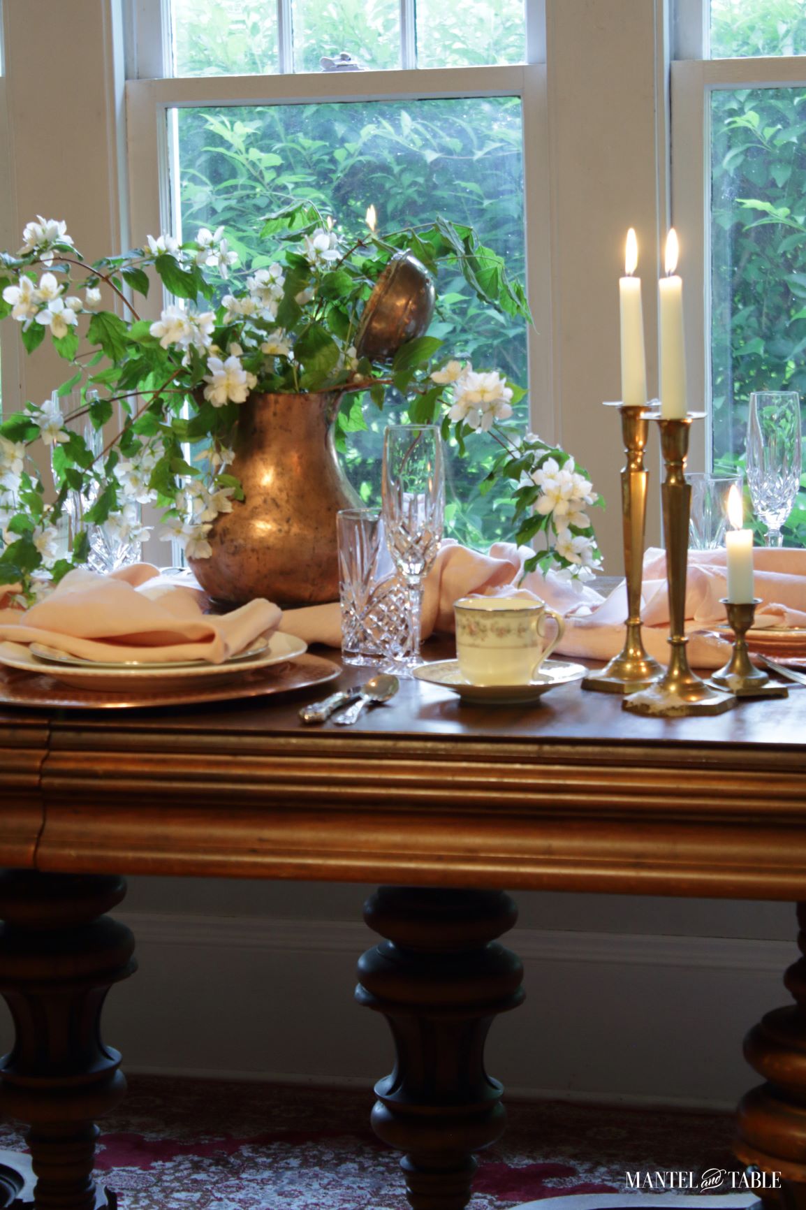 Blush table linens tablescape with candle glow