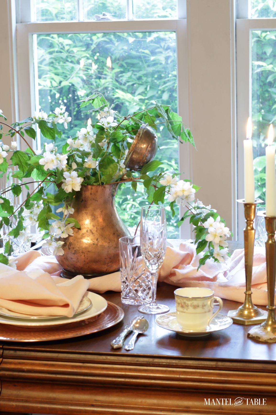 Blush table linens tablescape featuring teacup