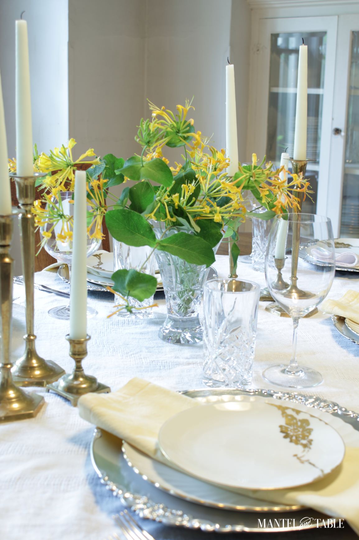 Closeup of vase of honeysuckle flowers on a dinner table
