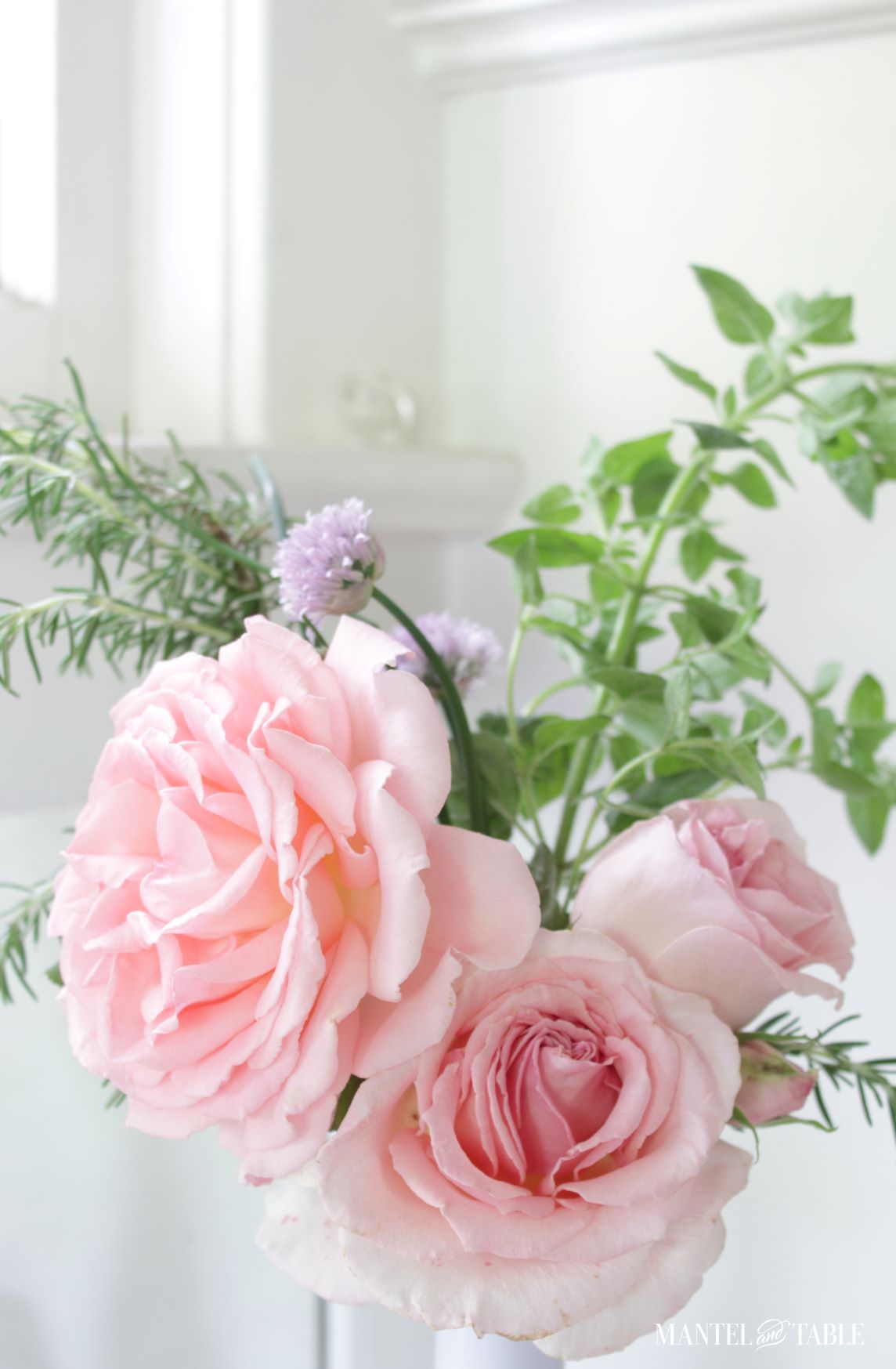 Roses in a wine bottle with herbs