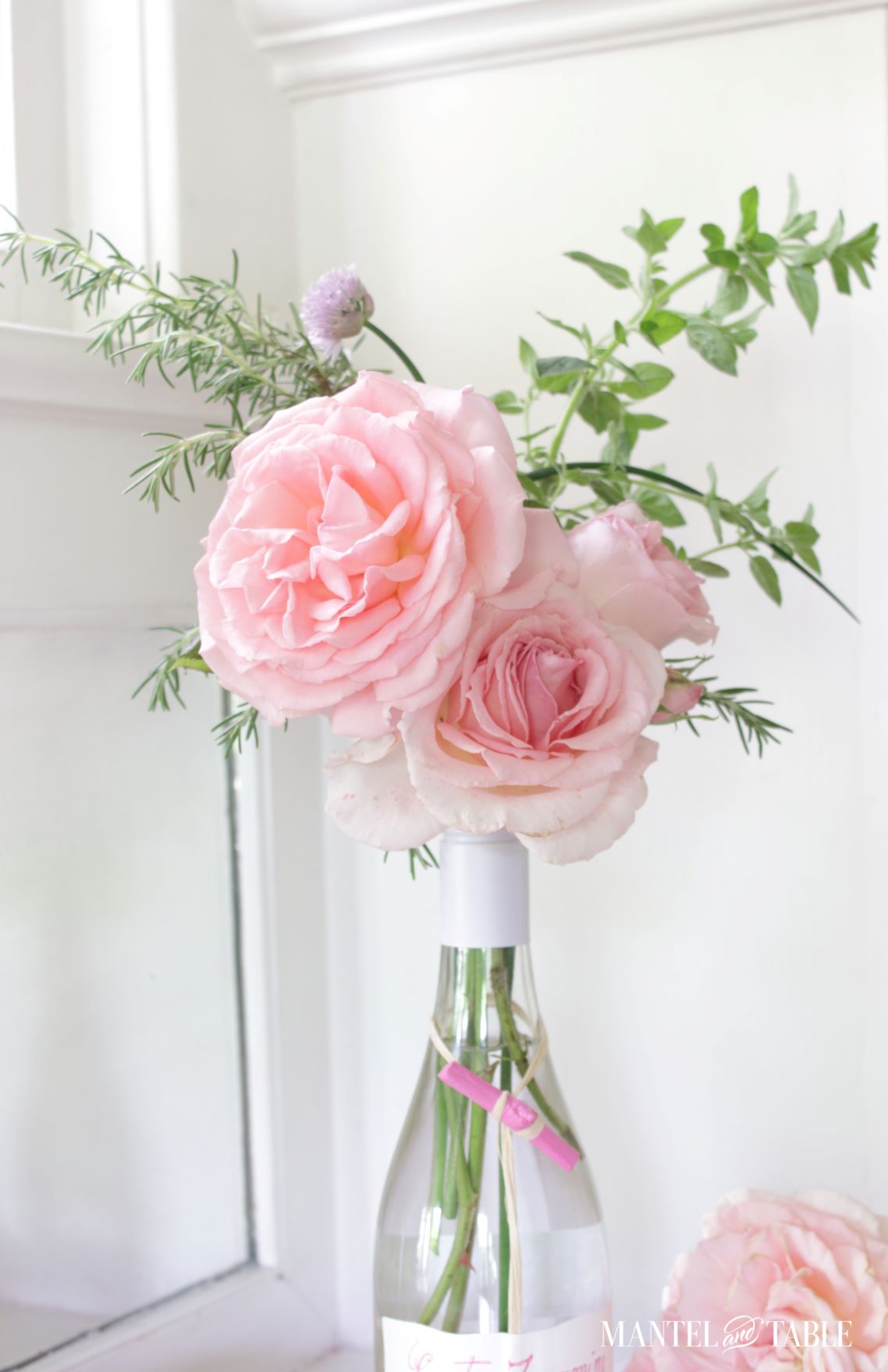Arrangement of pink roses and herbs