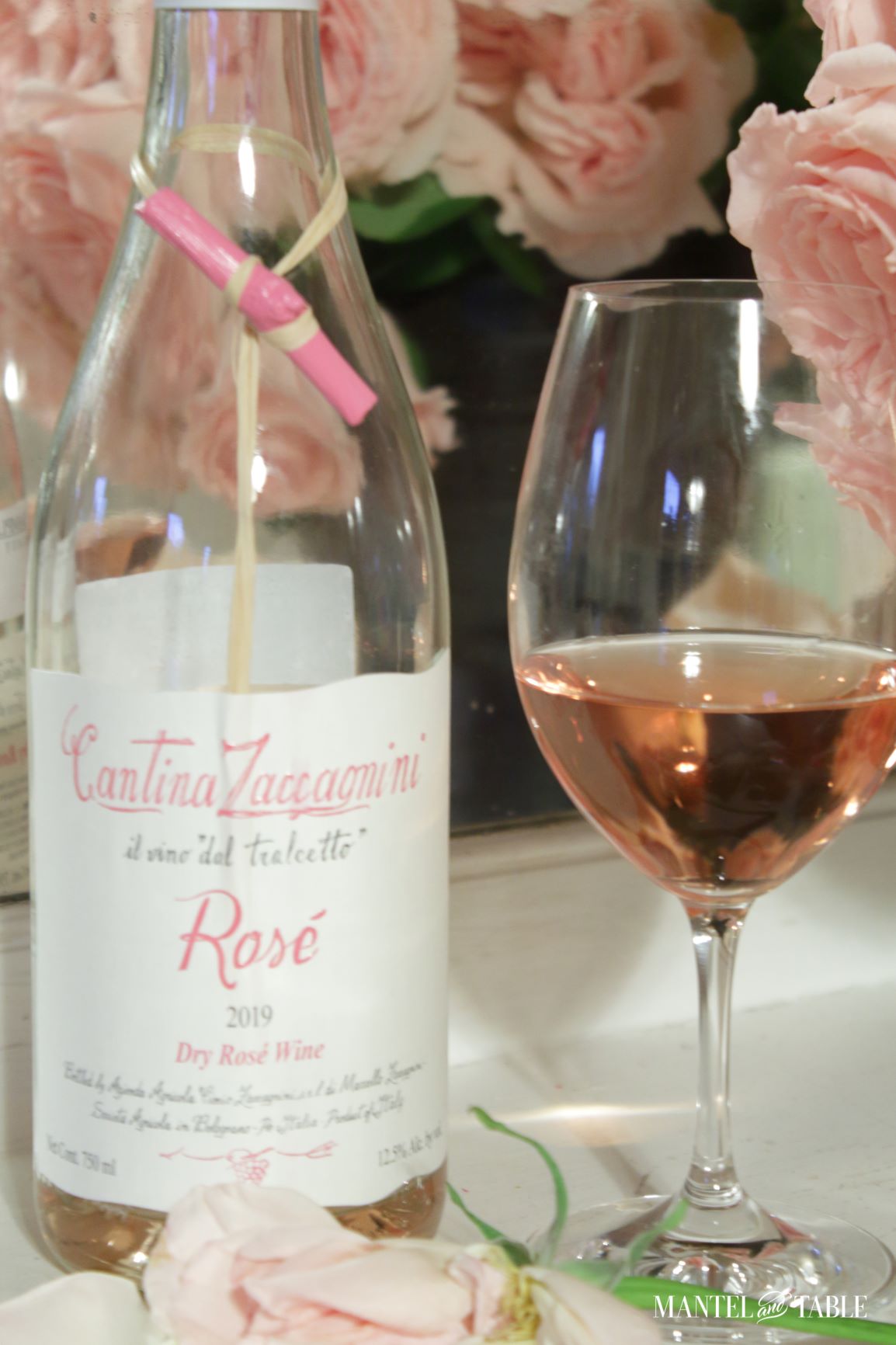 Closeup of wine bottle and glass of wine with roses