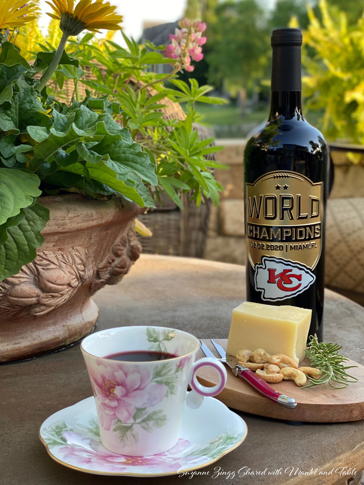 Rose teacup with appetizer and KC Chiefs comemorative wine bottle