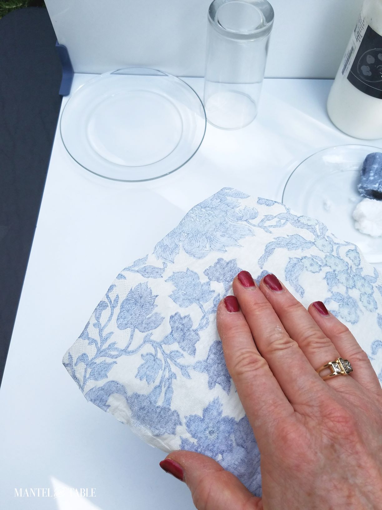 A hand pressing the napkin onto the DIY plate