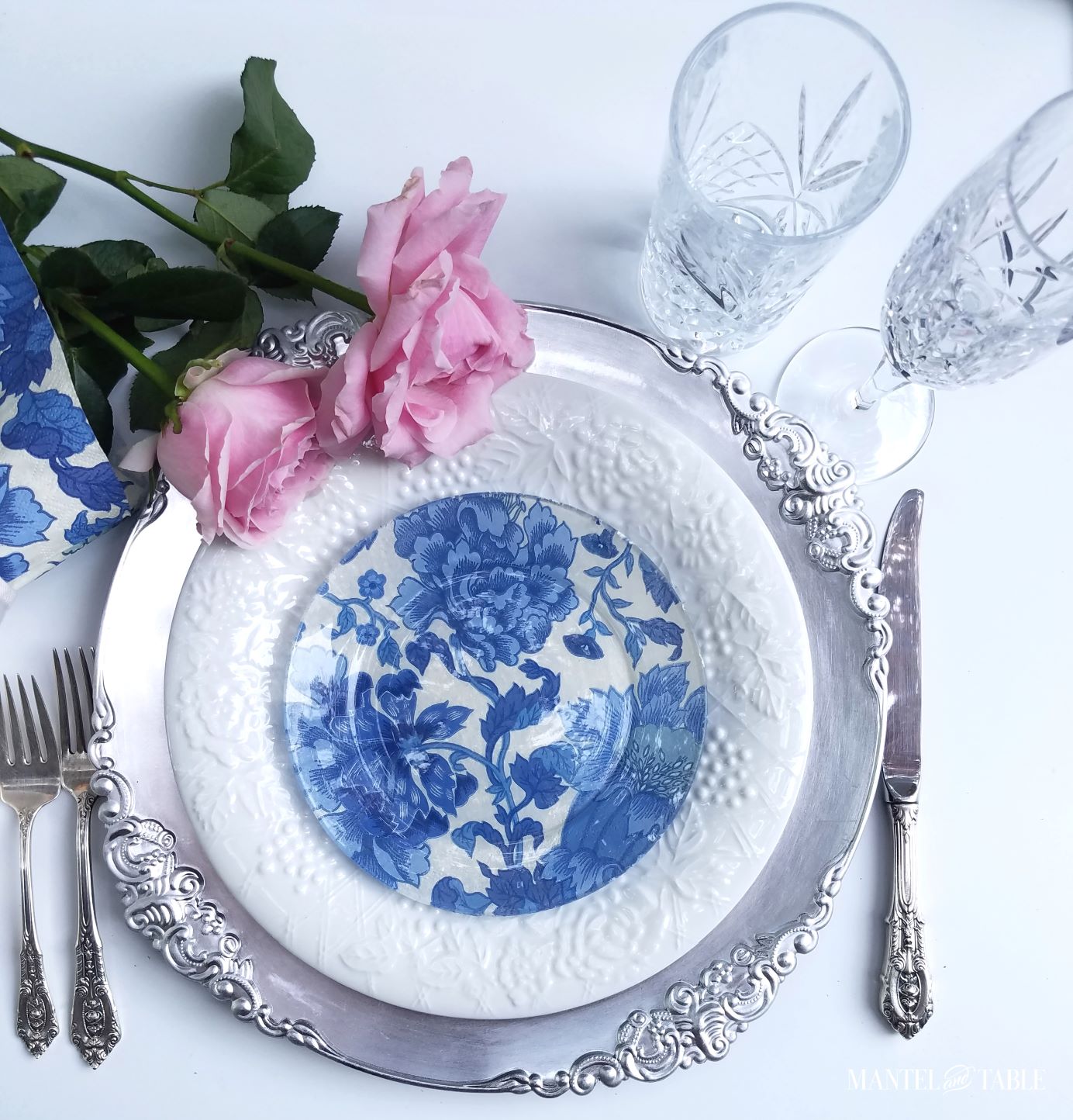 Place setting with the blue and white DIY plate, pink roses
