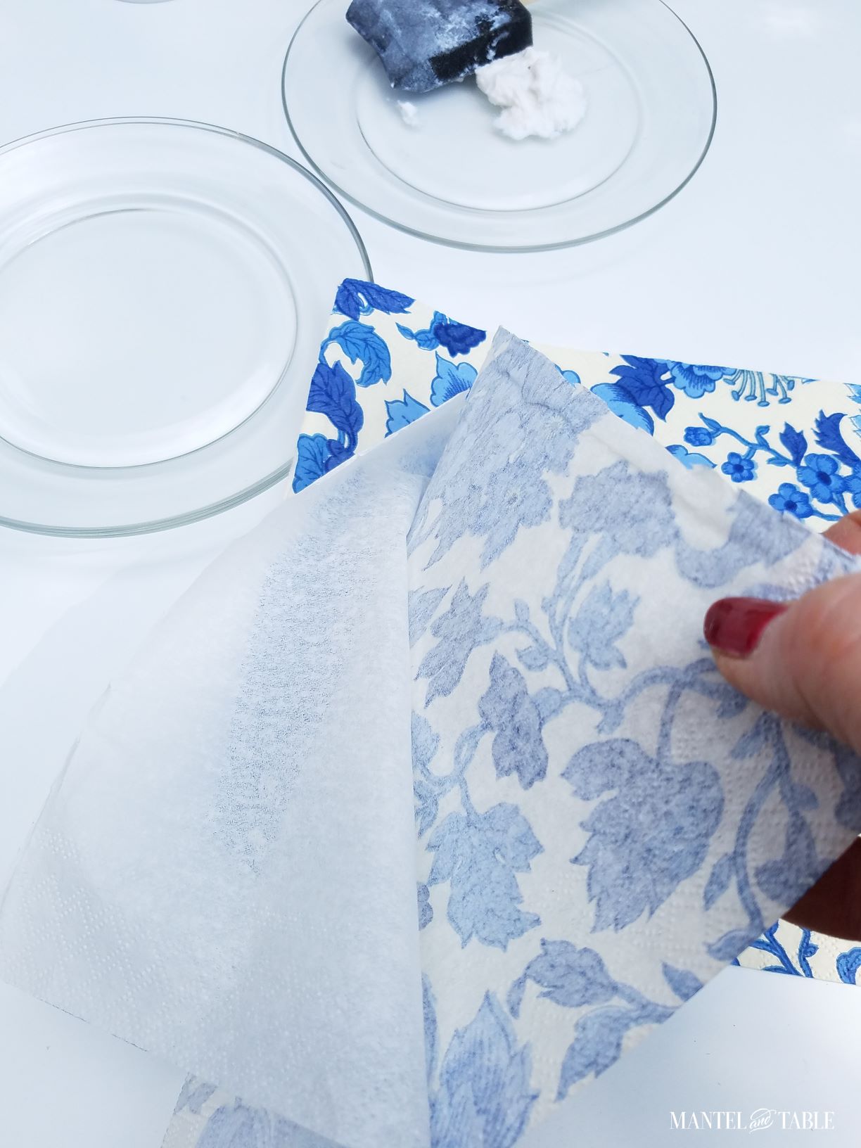 A hand separating layers of napkin for a DIY plate