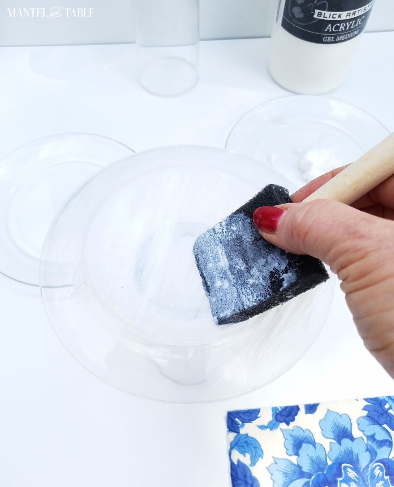 A hand painting acrylic medium onto the back of the DIY plate