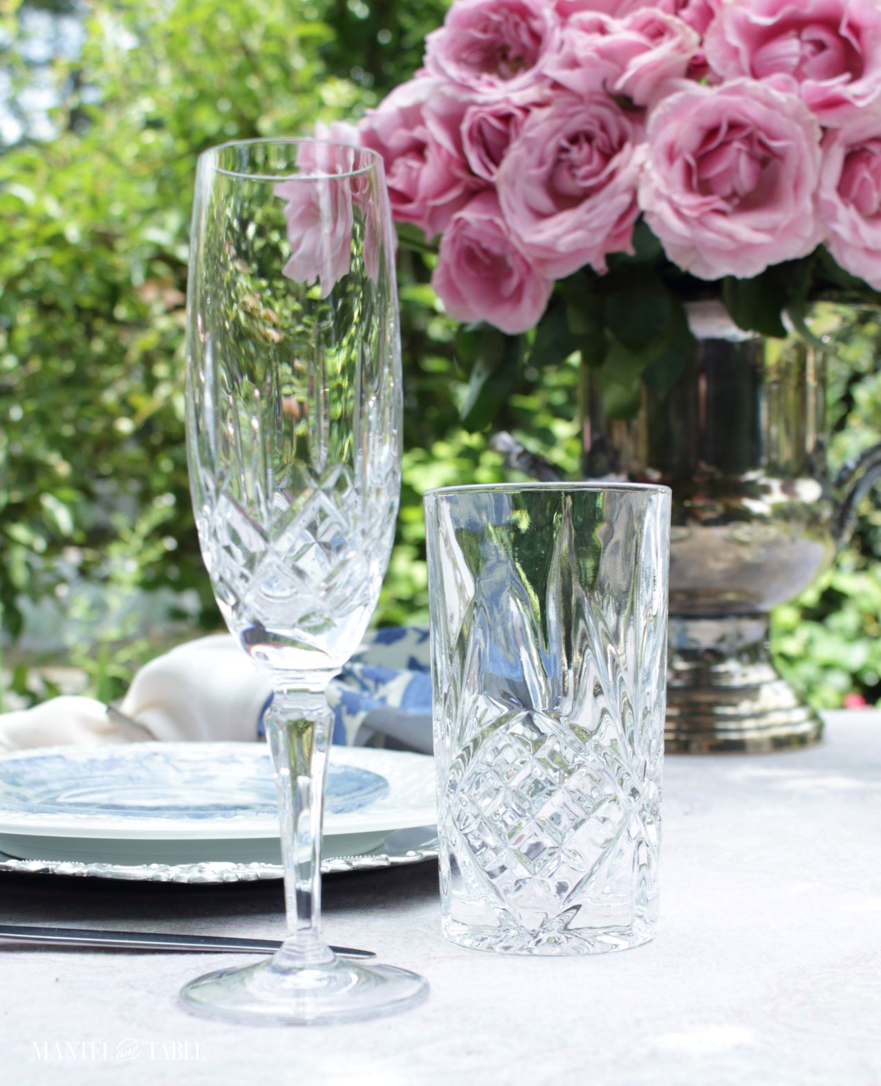 Pink roses and closeup of crystal glasses in table setting