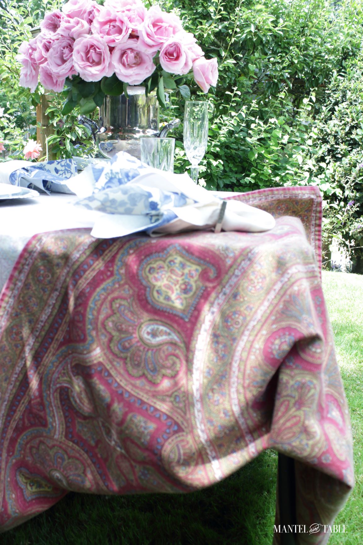 pink roses, blue & white tablescape with underside of tablecloth showing