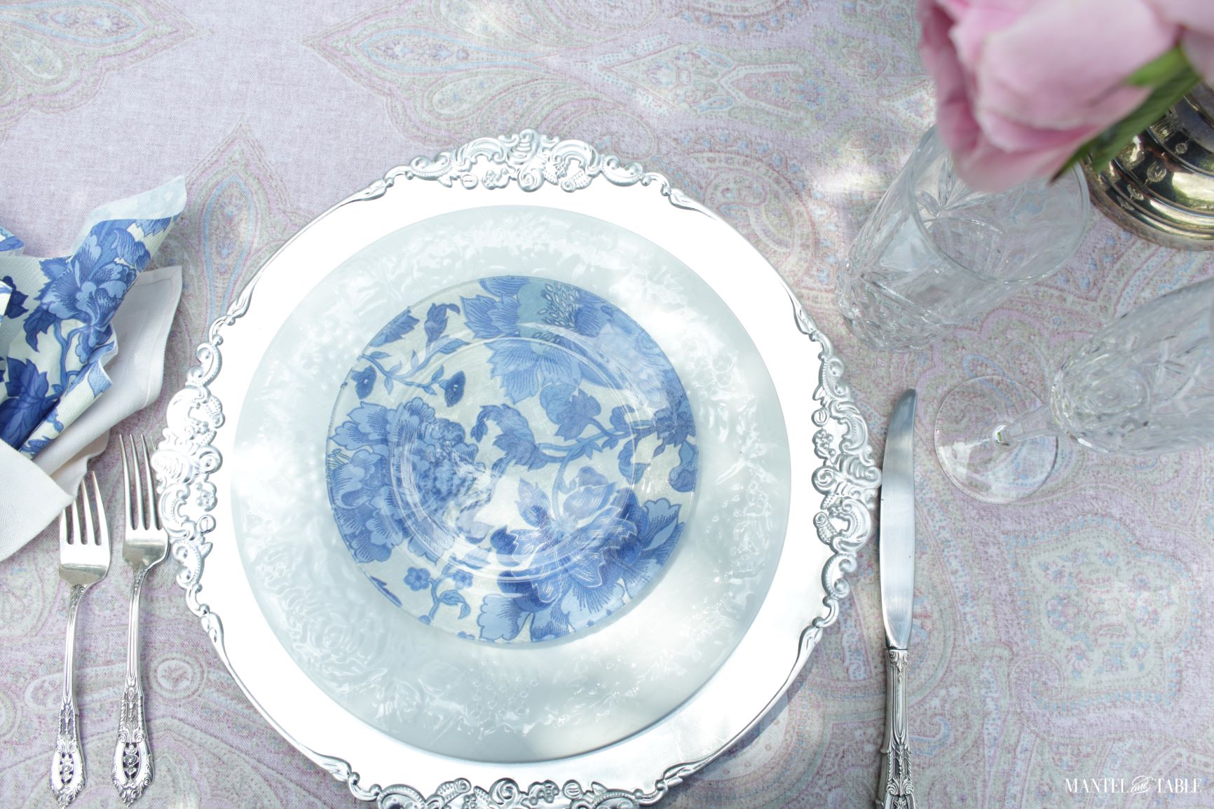 Top view of blue and white tablescape with pink roses