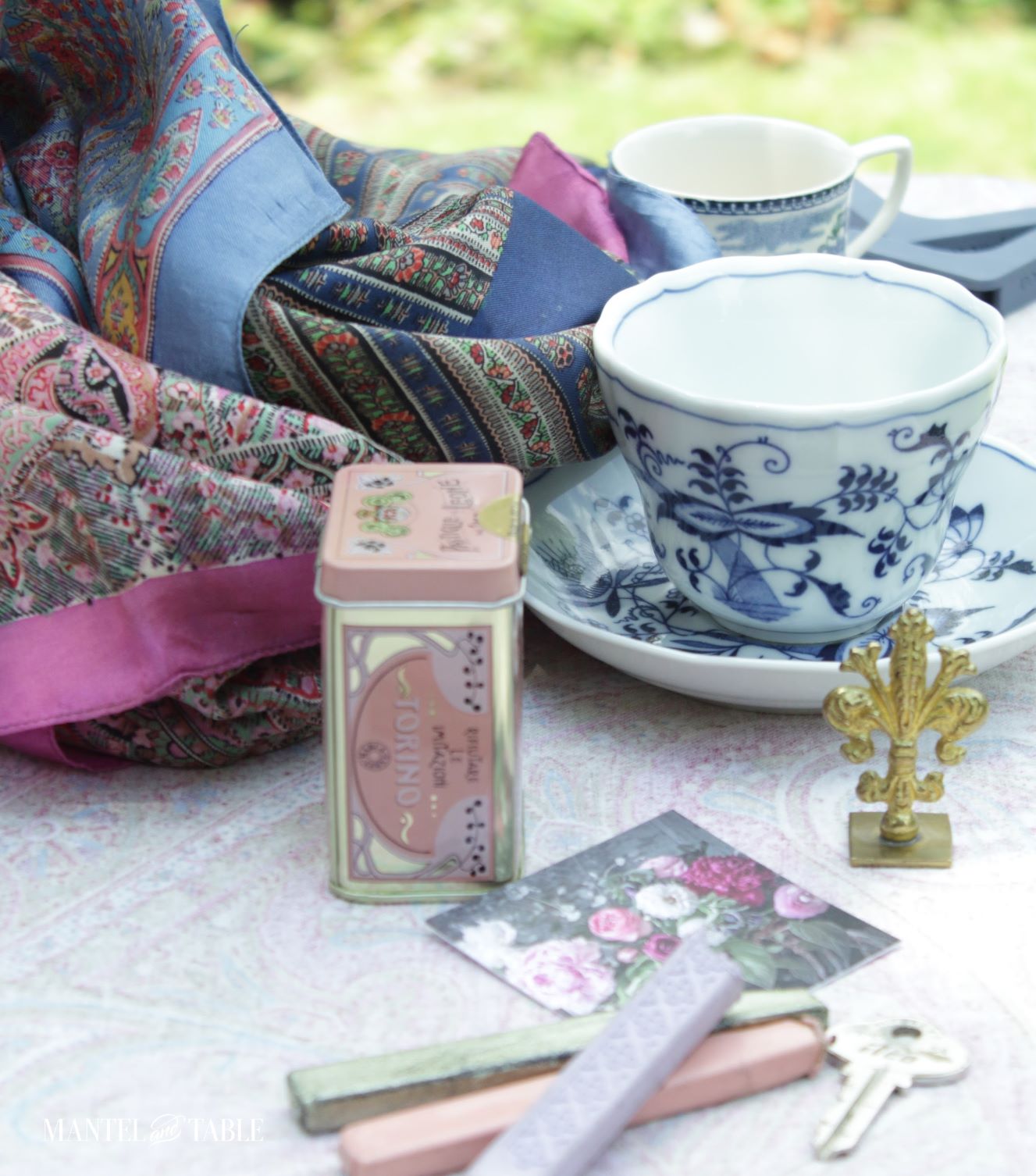 Collection of blue, pink, and metallic household items, including teacups