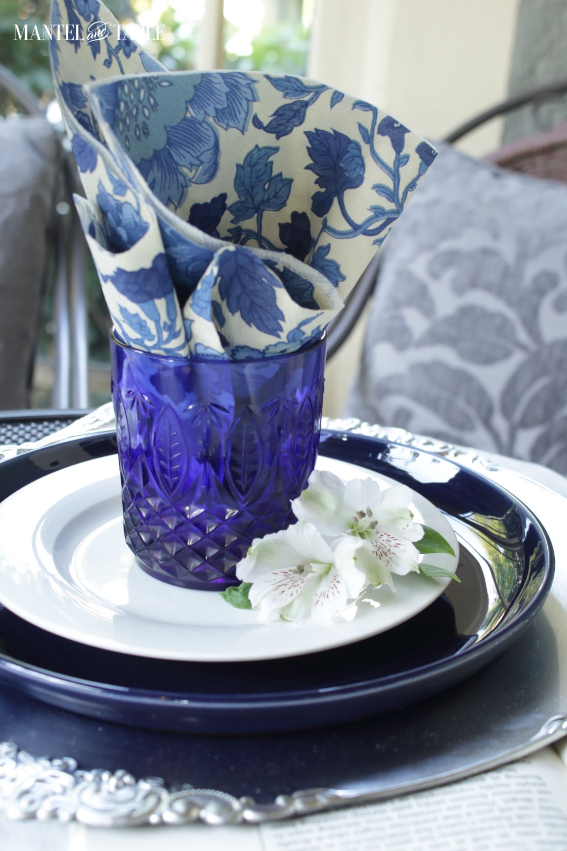 Blue and white tablescape - closeup of blue glass on plate stack