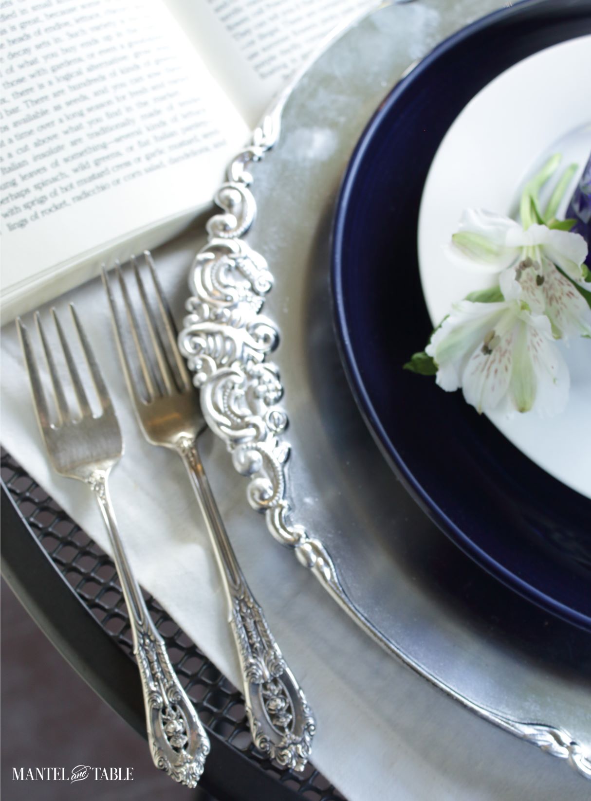Closeup of silver forks in blue and white tablescape