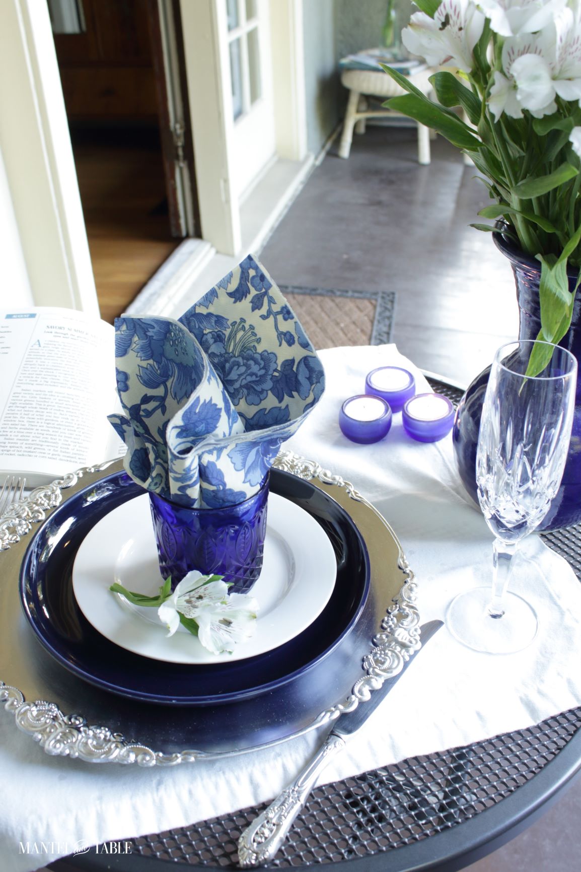 View across the porch from the blue and white tablescape