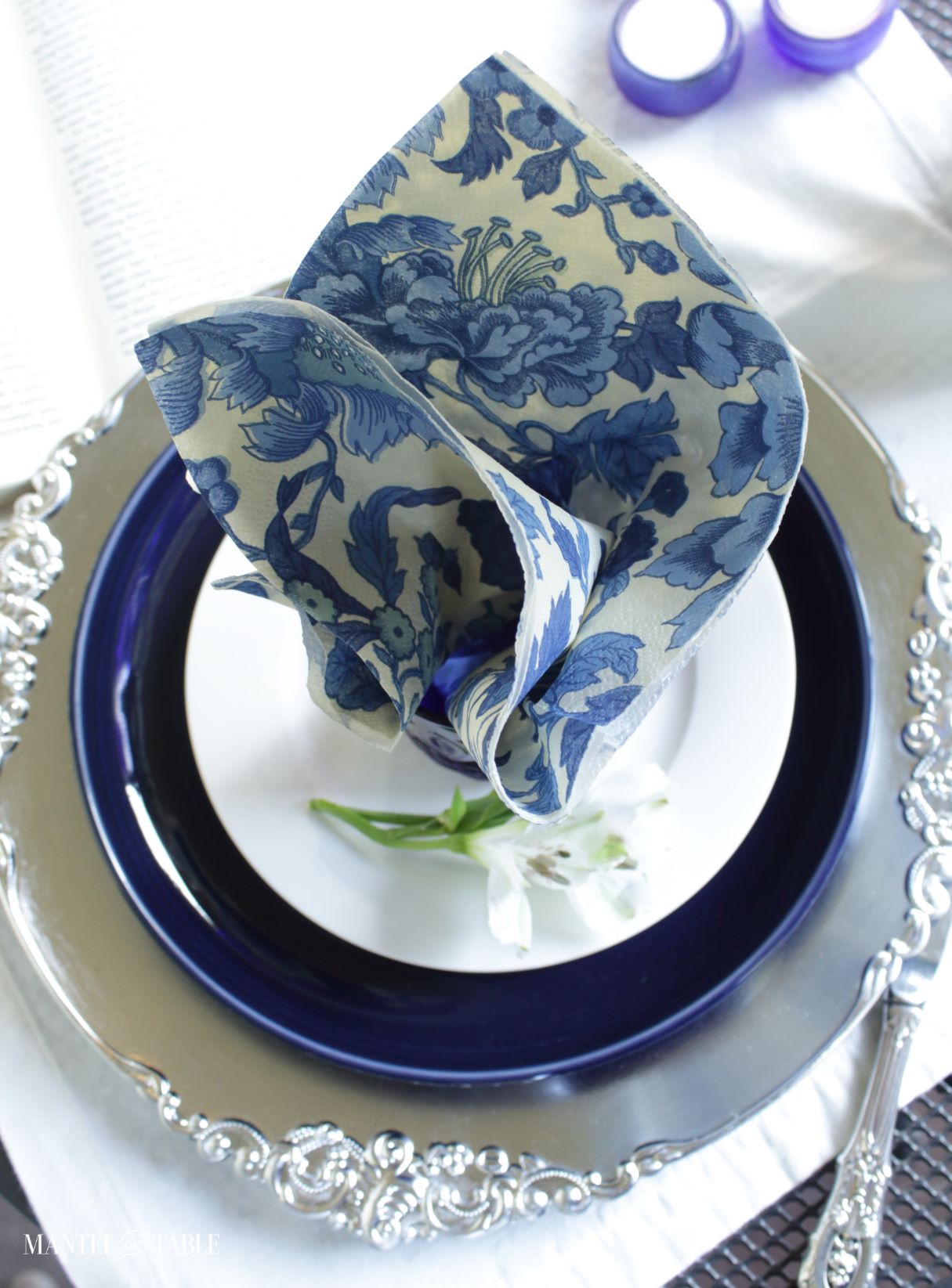 Blue and white tablescape - plate stack with blue and white floral paper napkin in cup