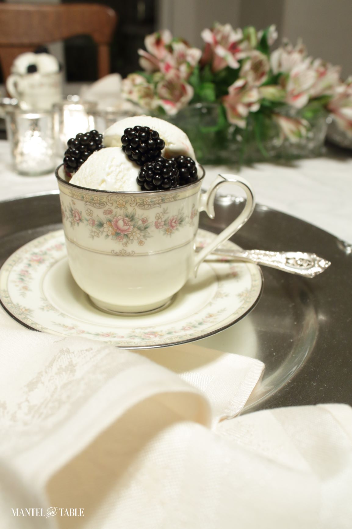 elegant teacup with vanilla ice cream and blackberries