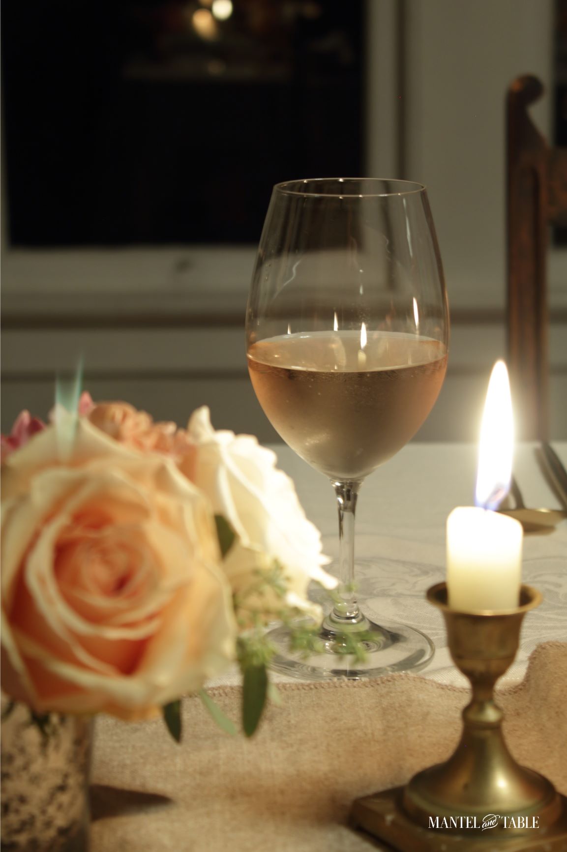 closeup of glass of rosé wine on table