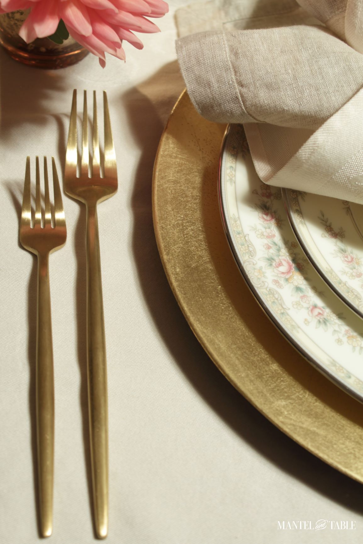 closeup of gold forks at place setting
