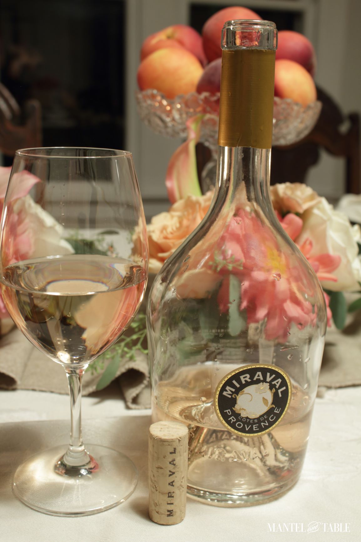 glass of wine and Miraval wine bottle