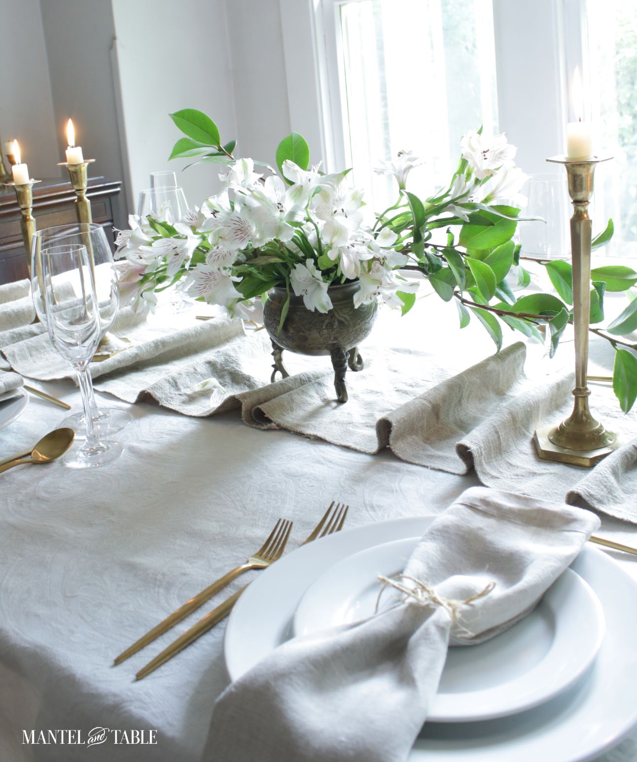 White place setting, linen table runner with flower centerpiece