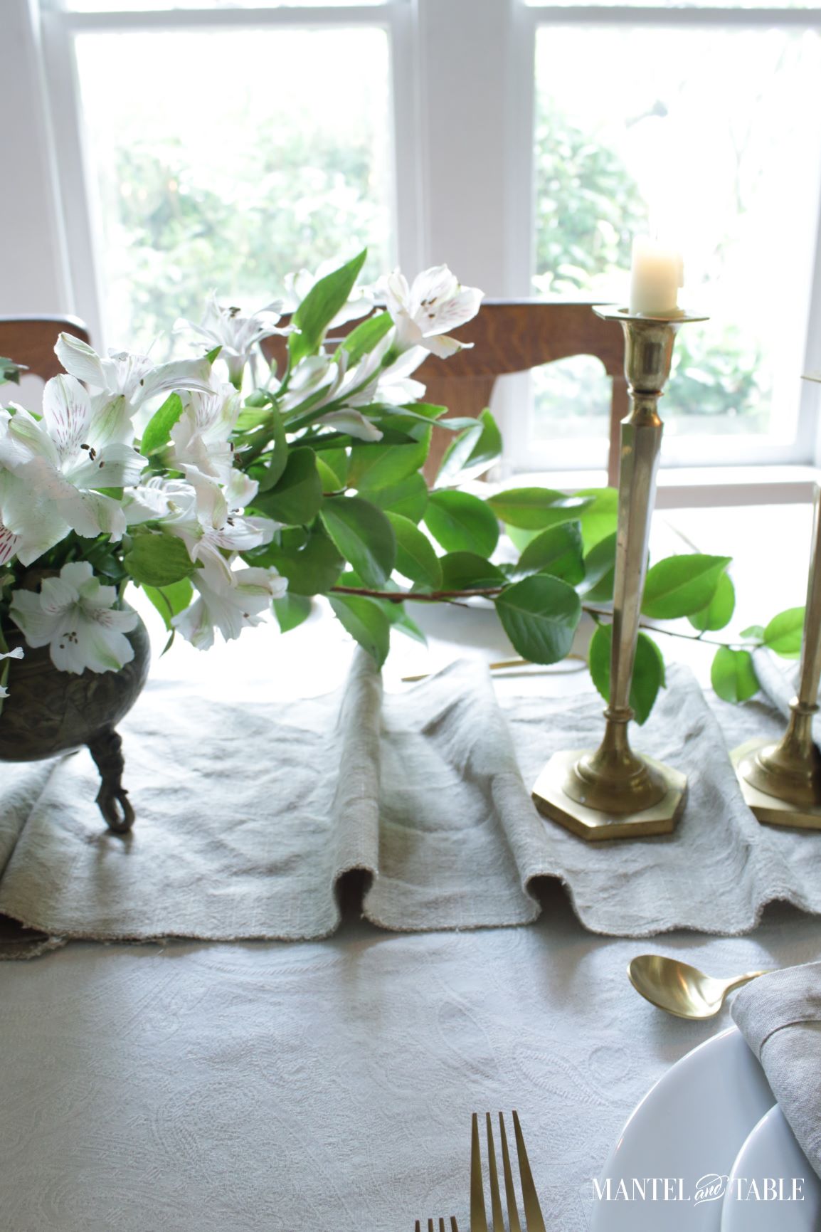 Closeup of table runner and white flower arrangement