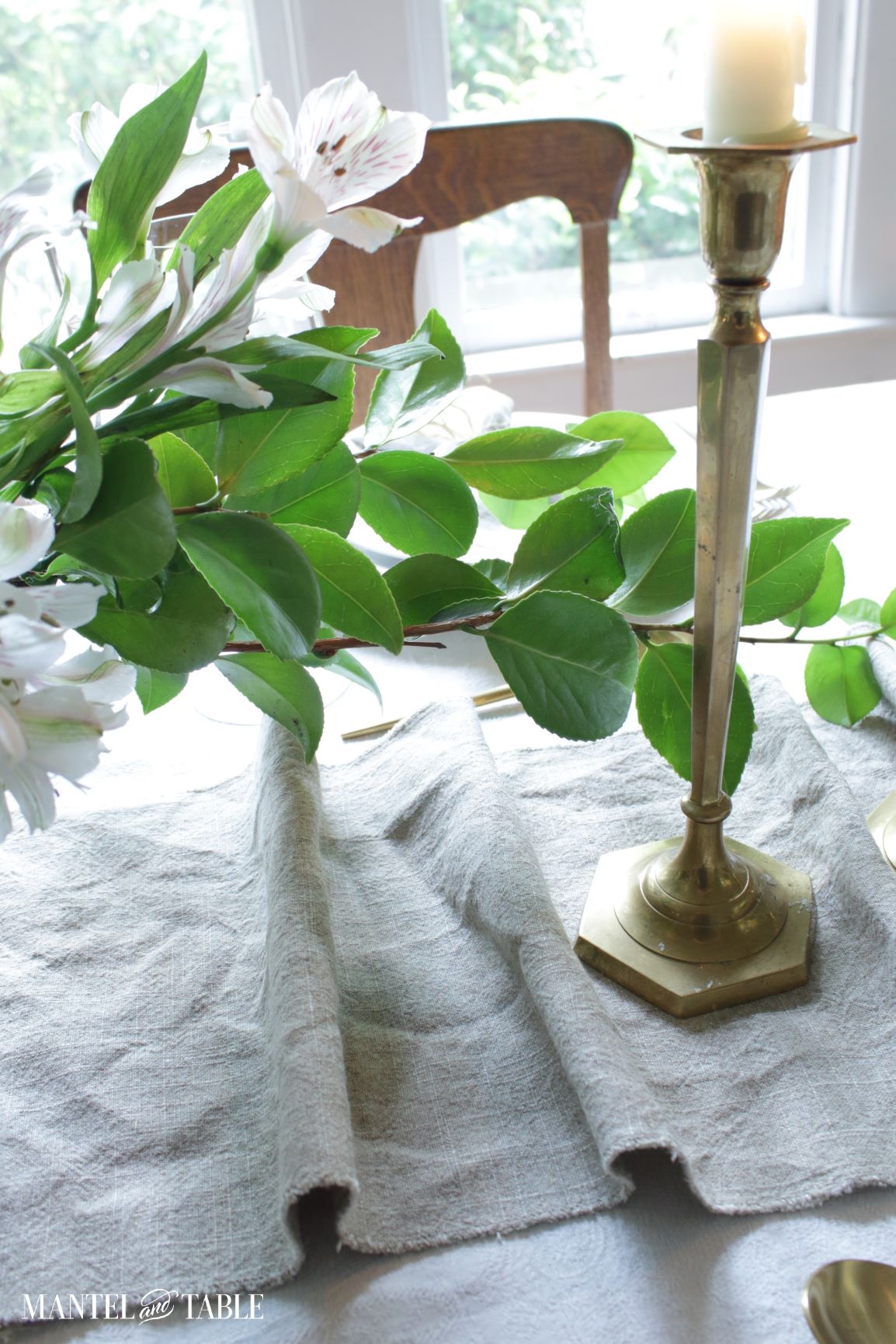 Closeup of runner, brass candle stick on table