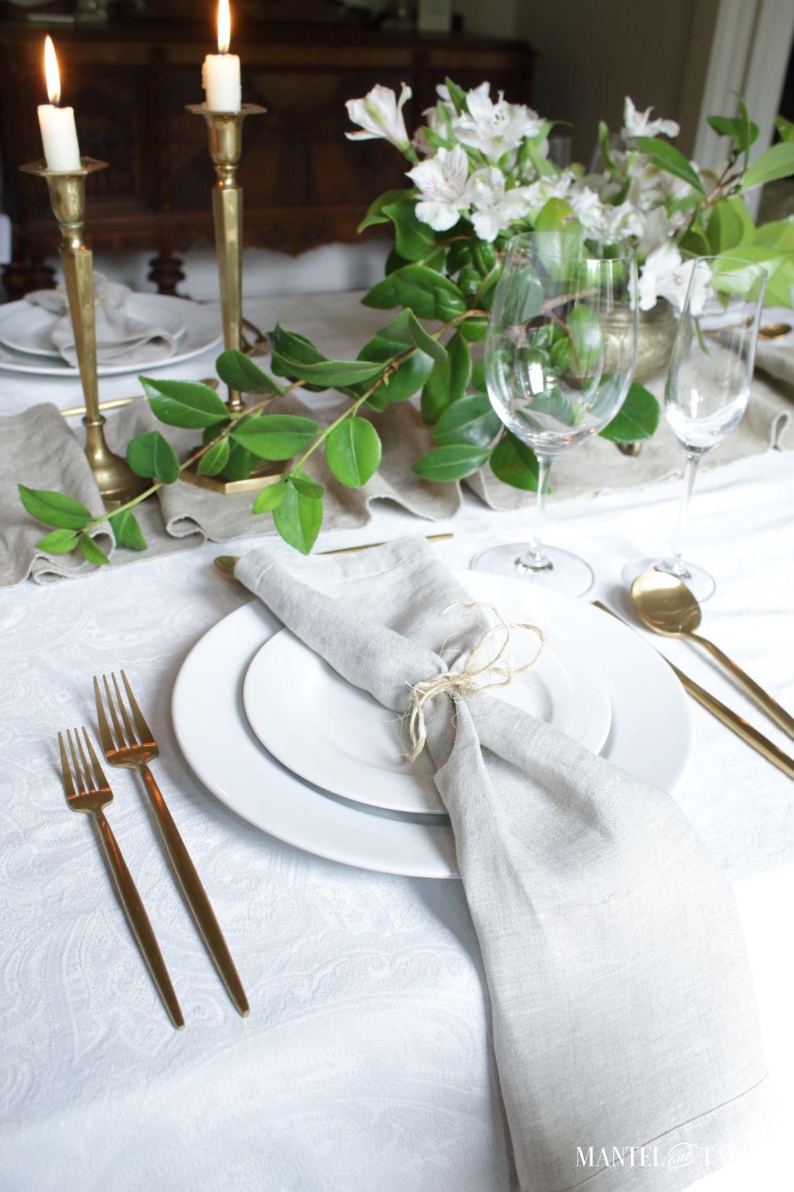Natural linen napkin on plate beside table runner
