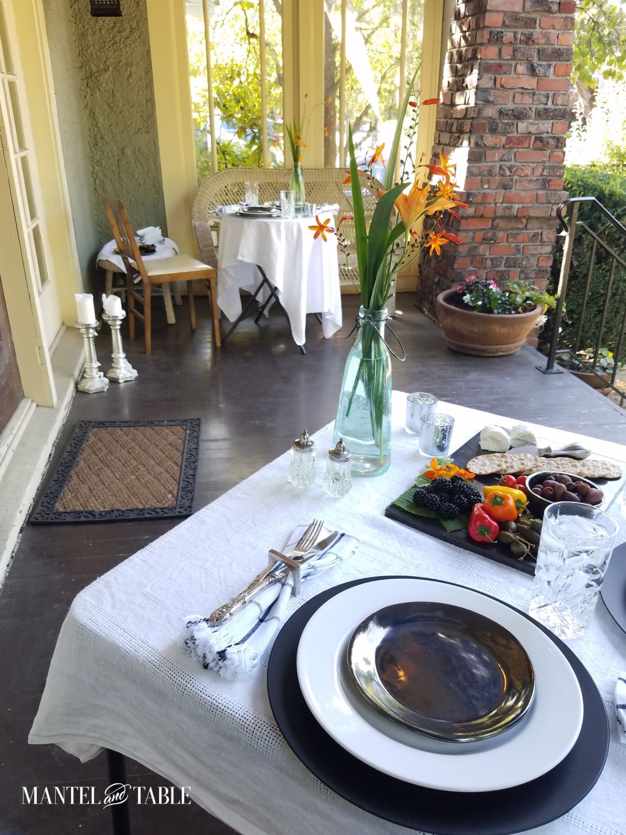 Closeup of two tables set for dinner on the porch
