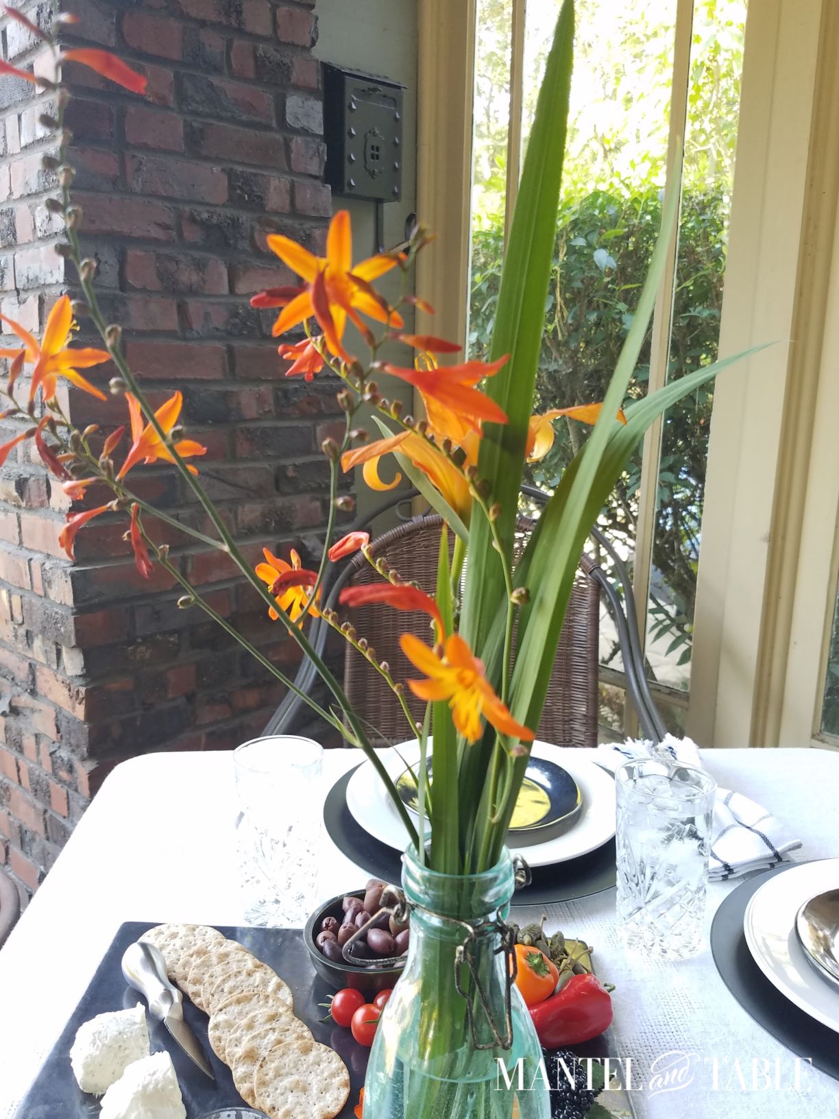 Closeup of orange flowers in a green glass bottle