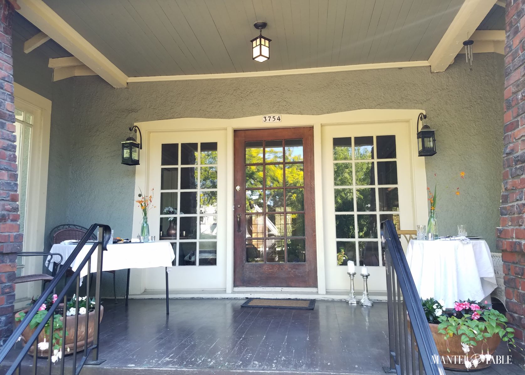 Full view of two dinner tables on the front porch