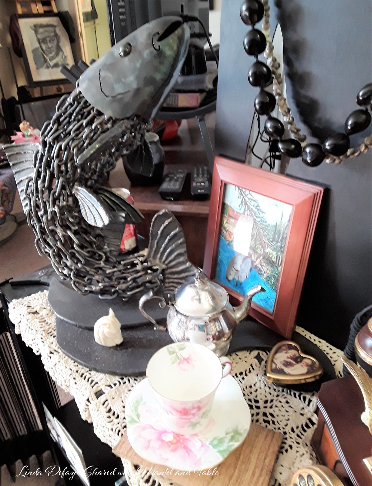 Metal fish sculpture and teacup in an artist's apartment studio at Somerset Lodge