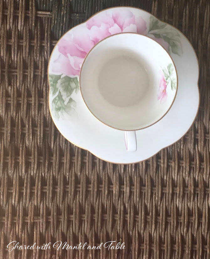 Pink and white cup on brown rattan table