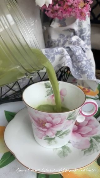 Pouring more matcha from glass jar into teacup