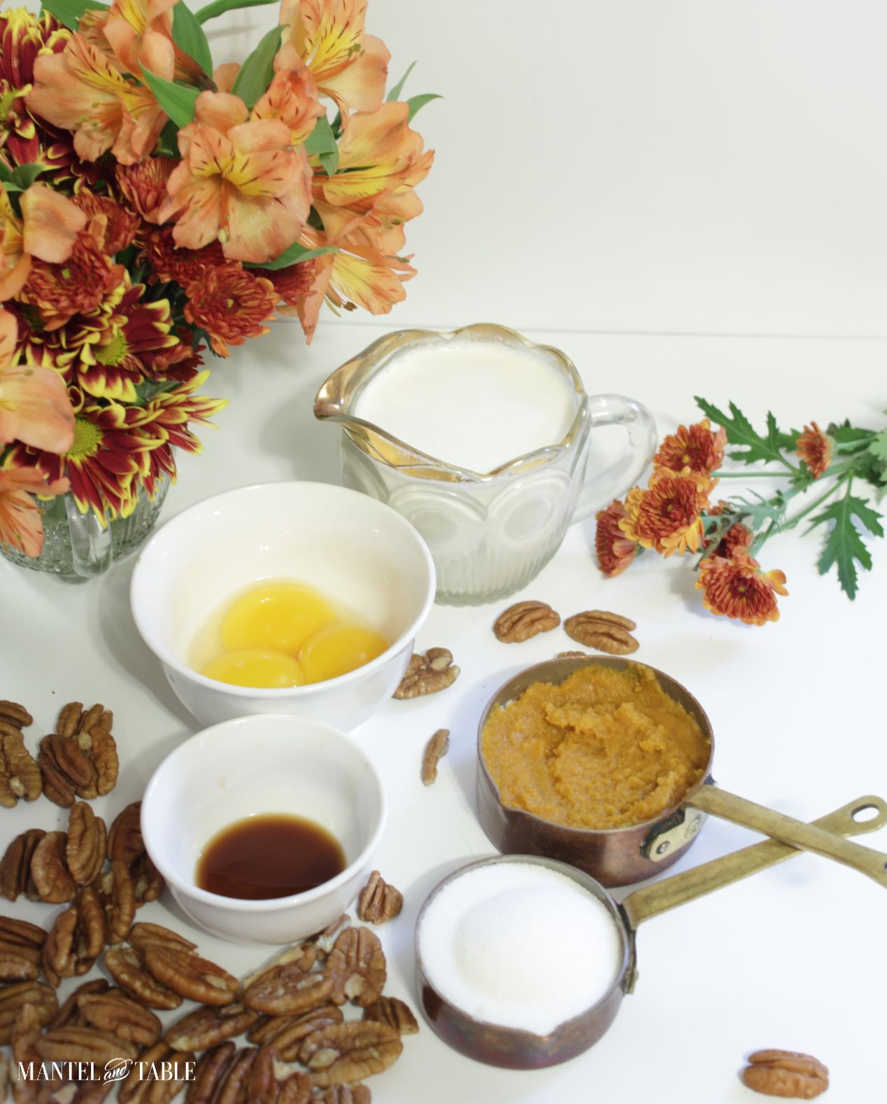 Pumpkin pot de creme ingredients in white bowls and copper measuring cups