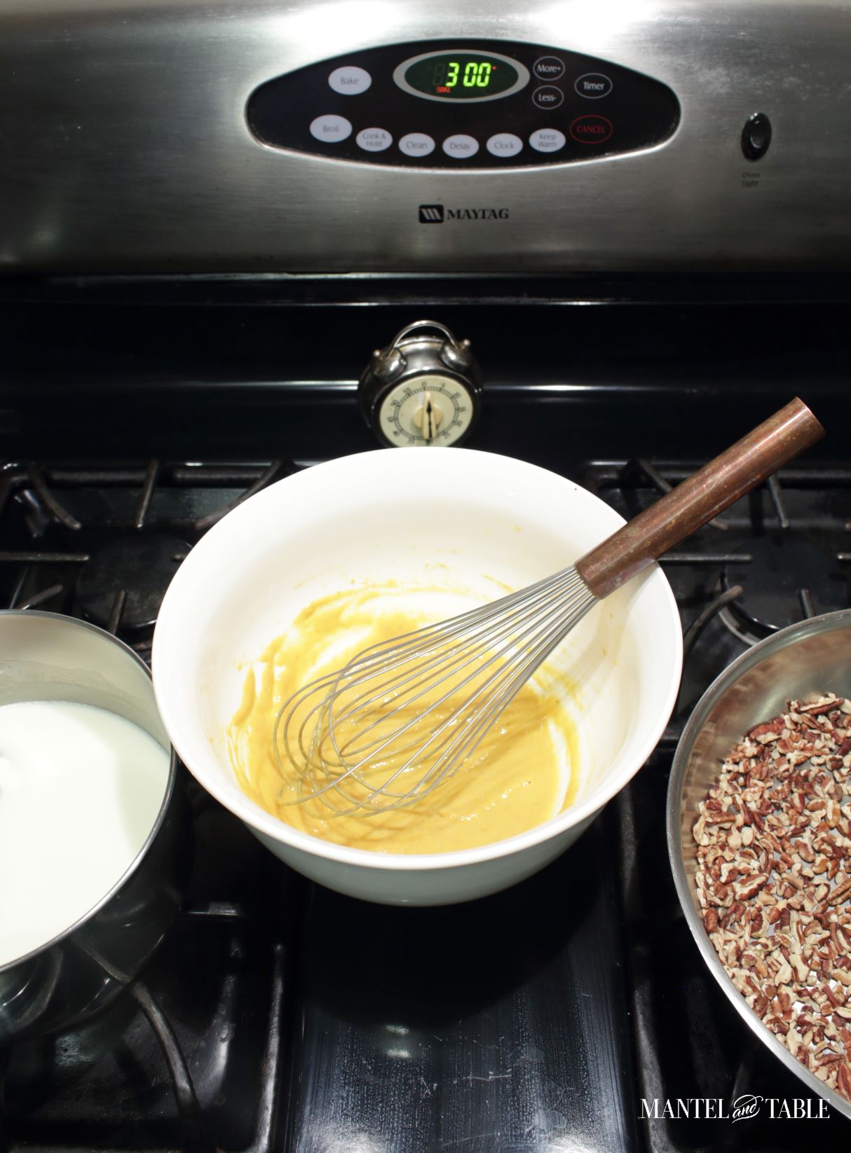 Saucepan of cream, bowl of pumpkin mix and pan of nuts on stove