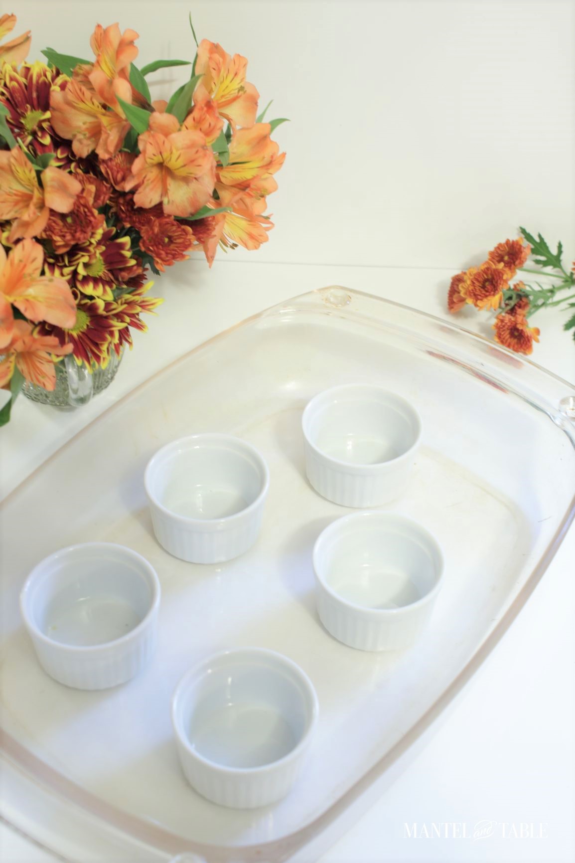 Pumpkin pot de creme ~ empty ramekins in clear baking dish