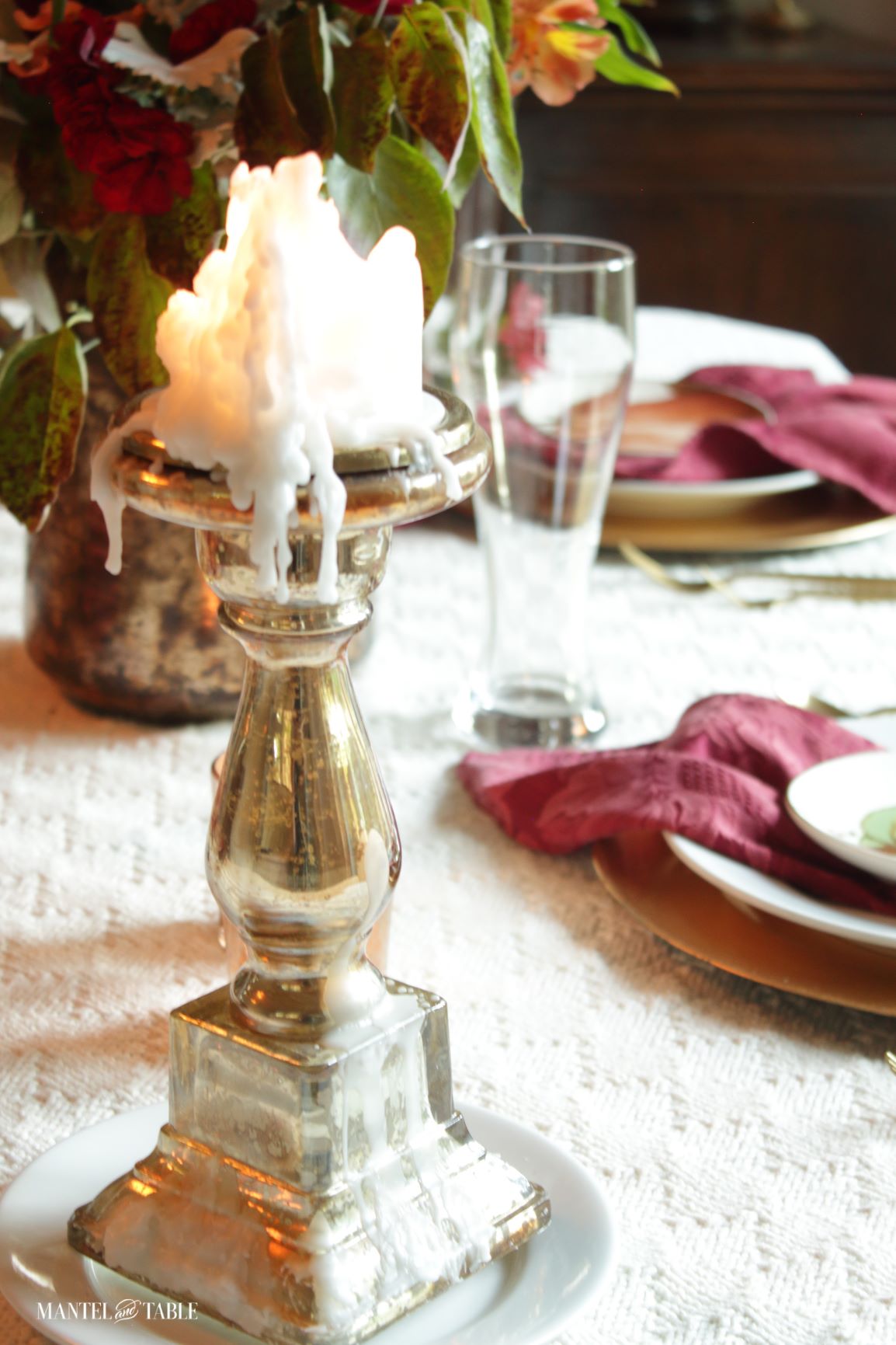 Red Fall Tablescape with closeup of lighted pillar candle