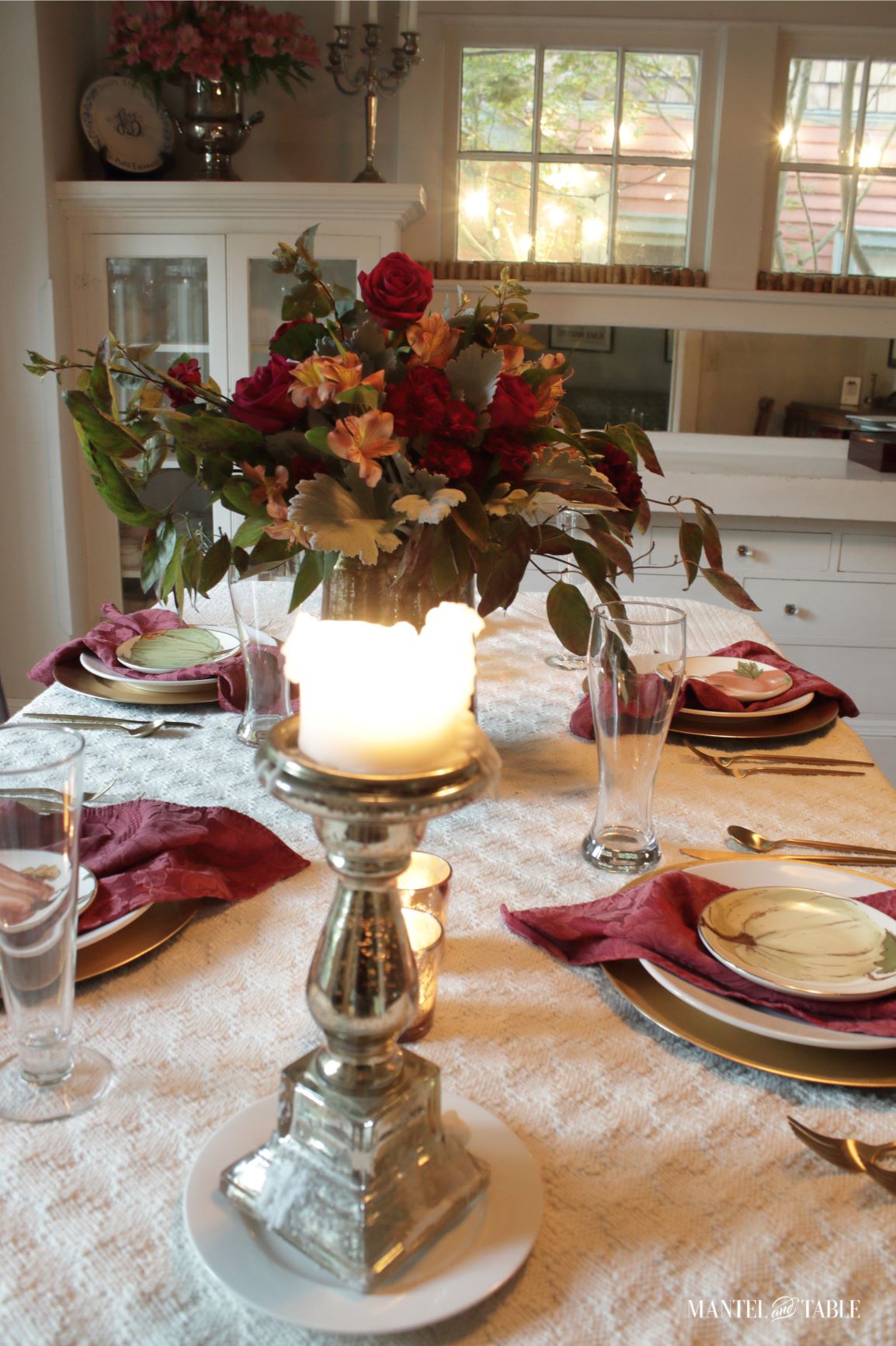 Red Fall Tablescape with lighted pillar candle in the foreground