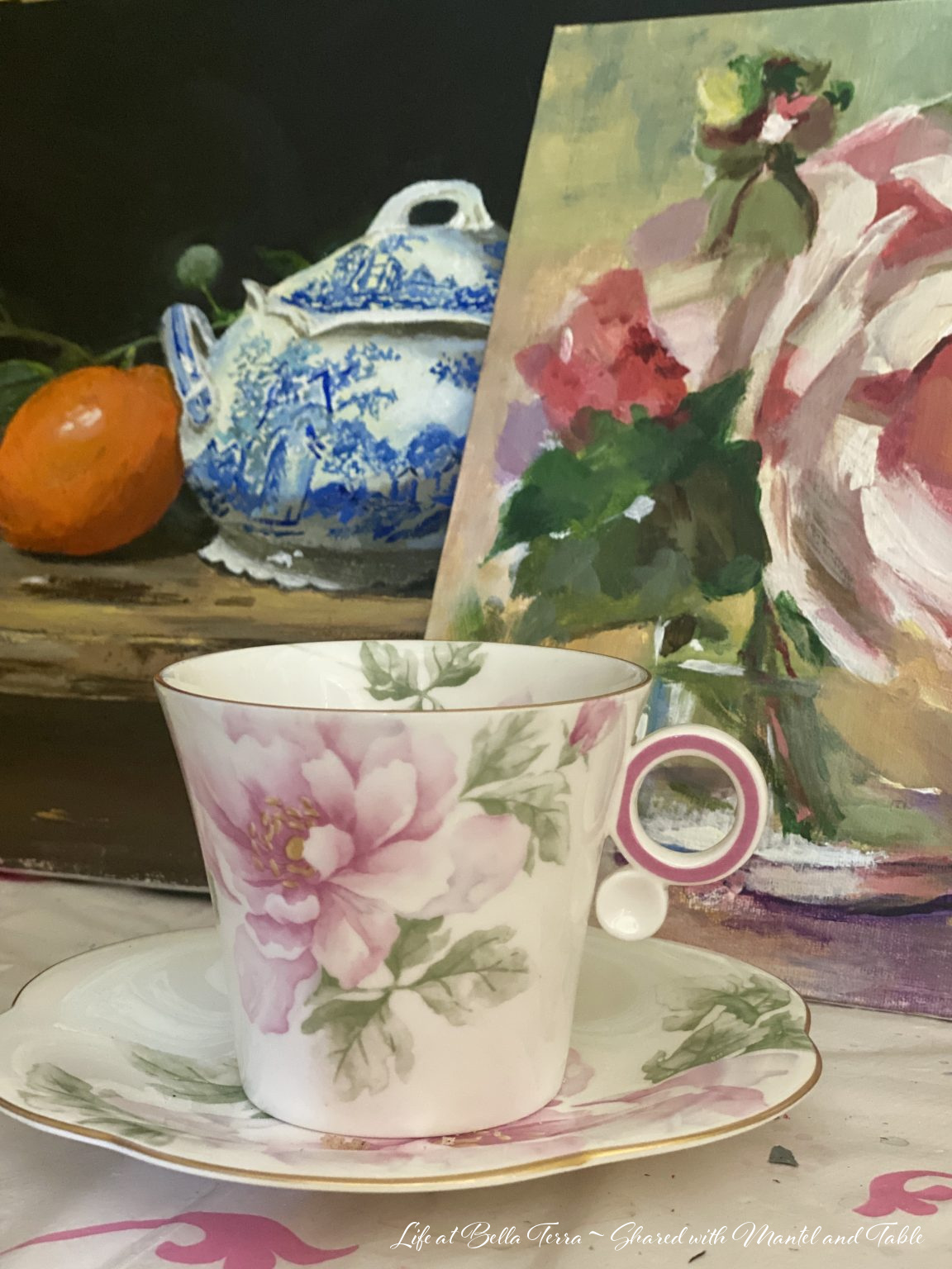 Teacup in art studio with oil paintings