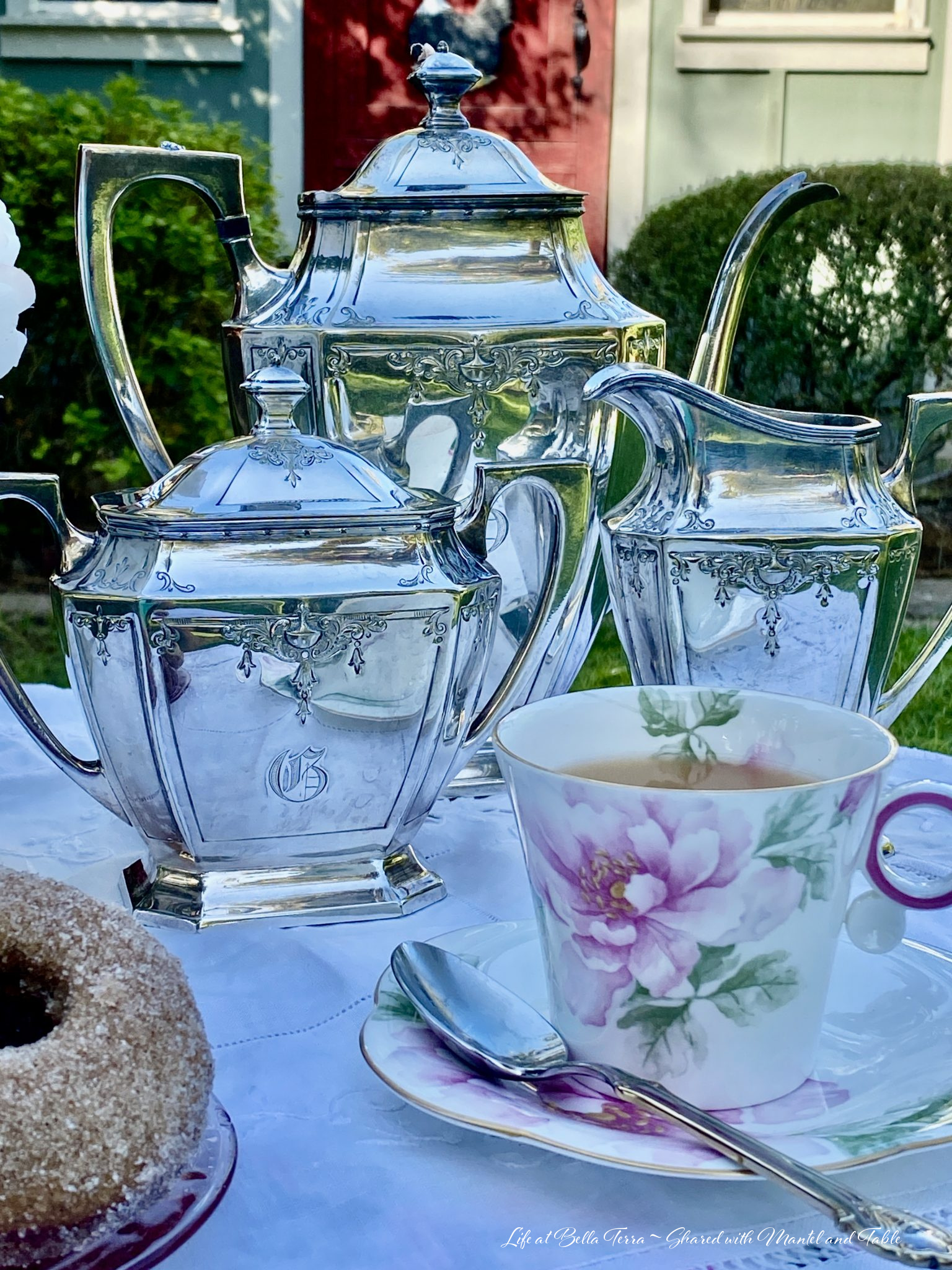 Pink & white teacup with ornate silver service