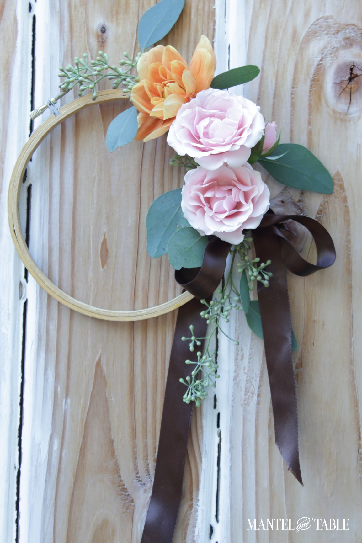 Close photo of wreath showing of brown satin bow