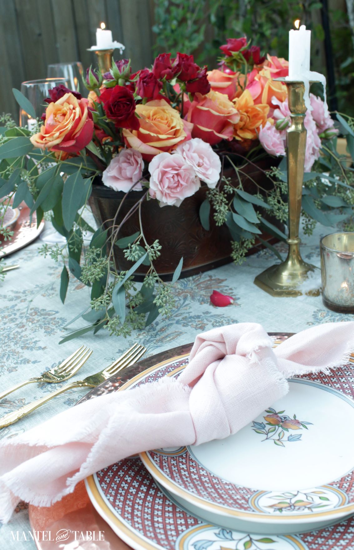 Blush pink napkin in beautiful table setting with flower arrangement