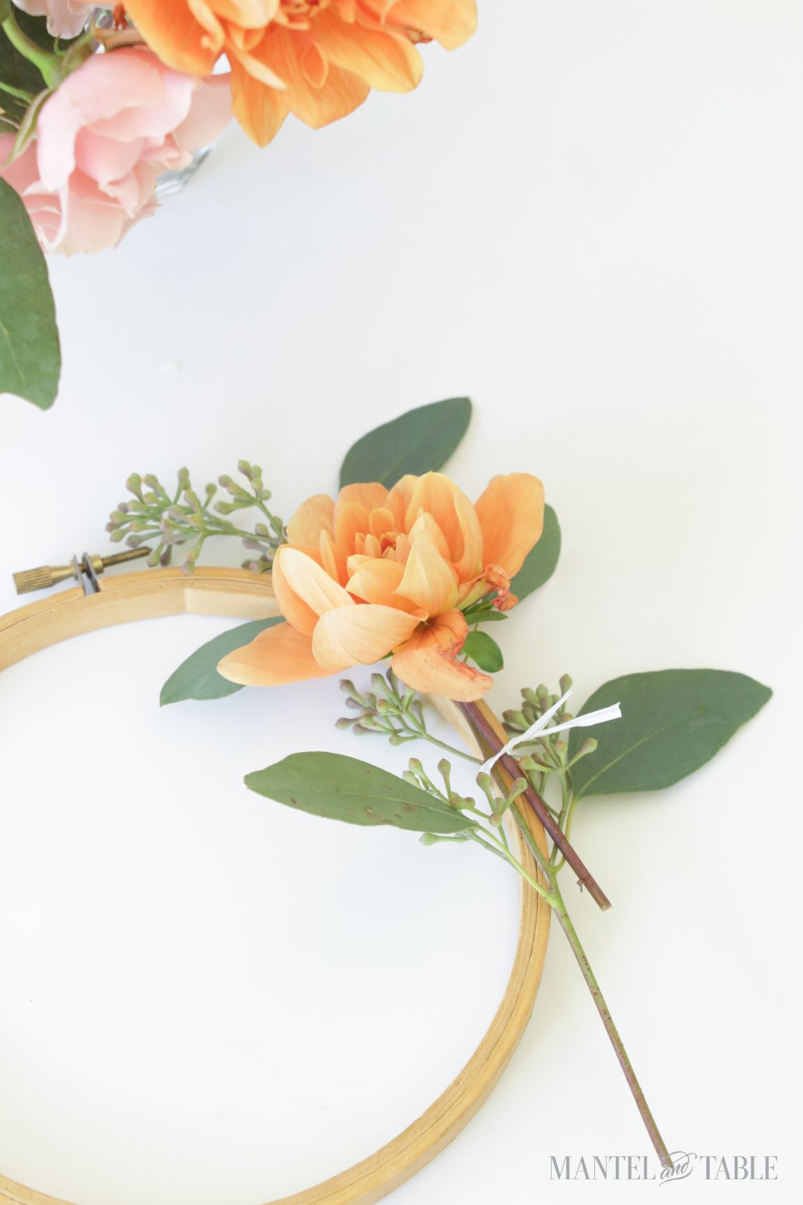 Hoop with seeded eucalyptus and peach dahlia attached