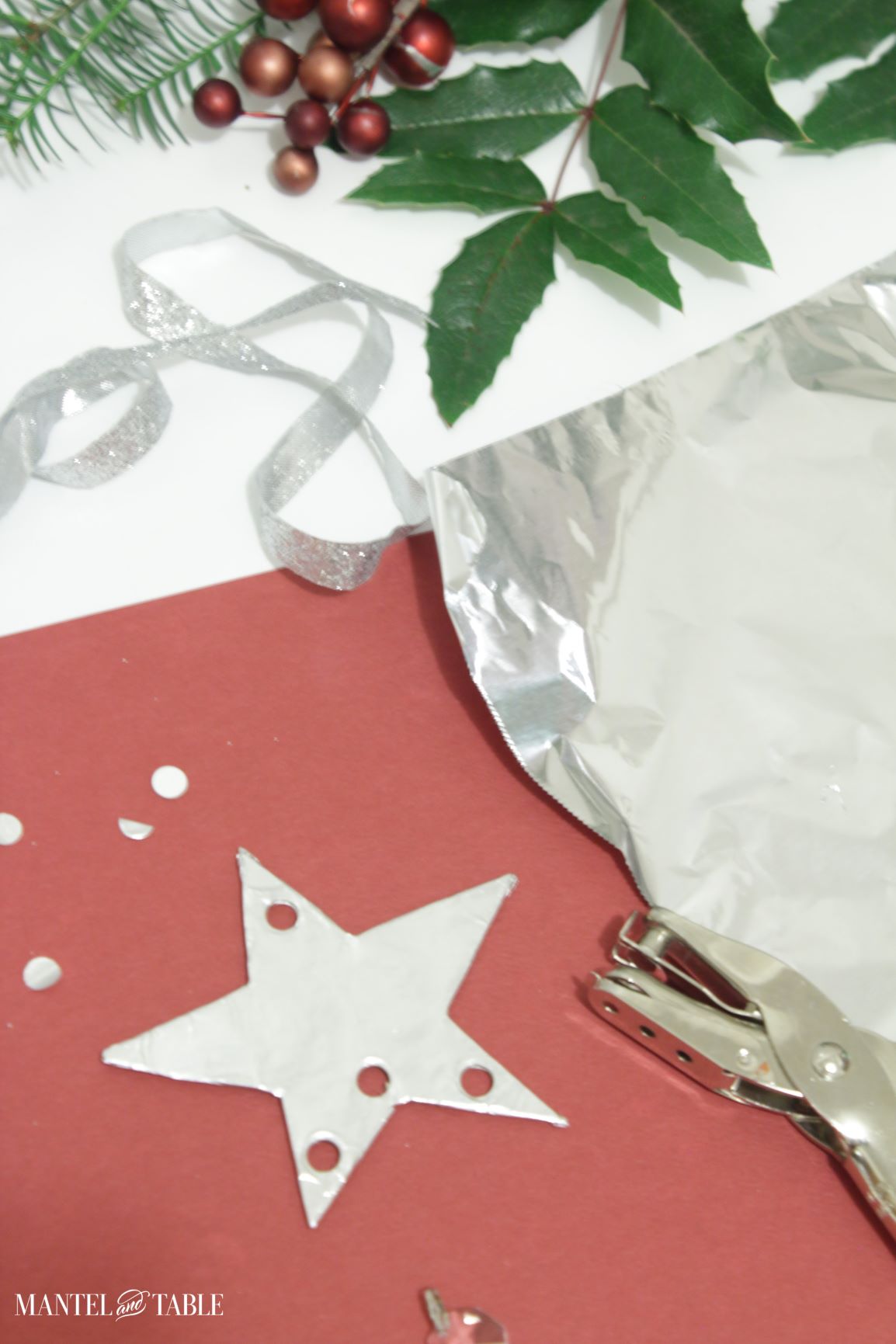 DIY Christmas Ornament star cutout with holes punched - 3 in the bottom, 1 in the top