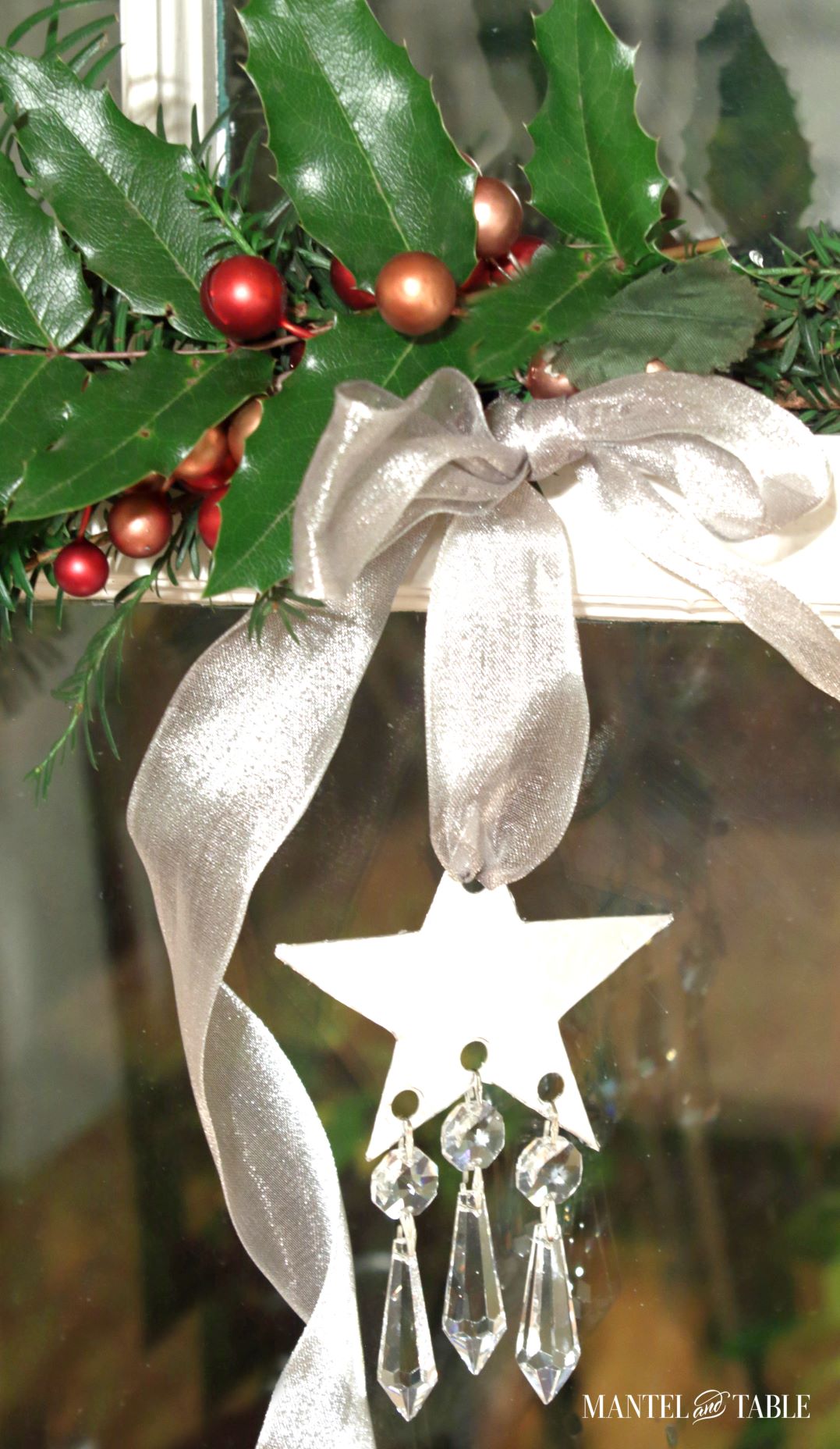 DIY Christmas Ornament hanging on window frame with holly and berries