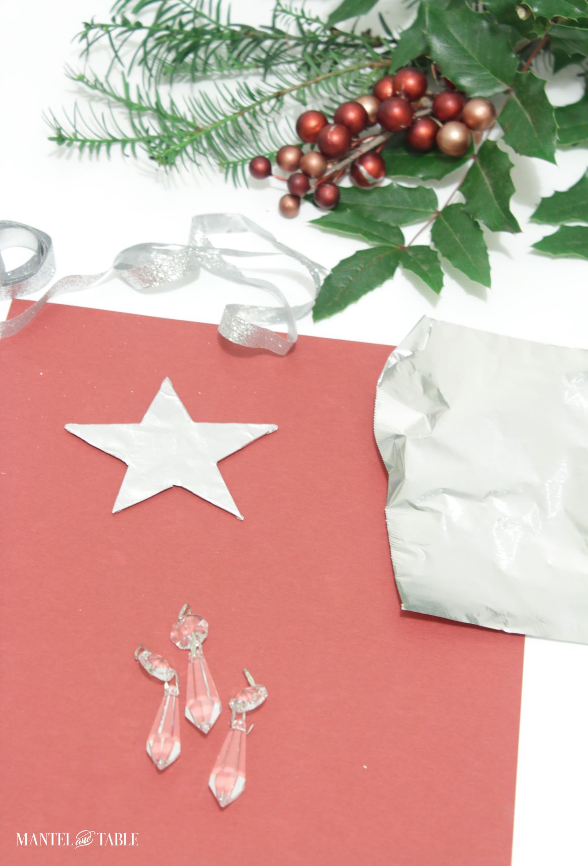 DIY Christmas Ornament star wrapped in foil, with other supplies